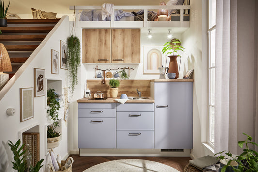 Küche in Pastelblau mit Einbaugeräten , Spüle und Mischbatterie und Kochfeld 